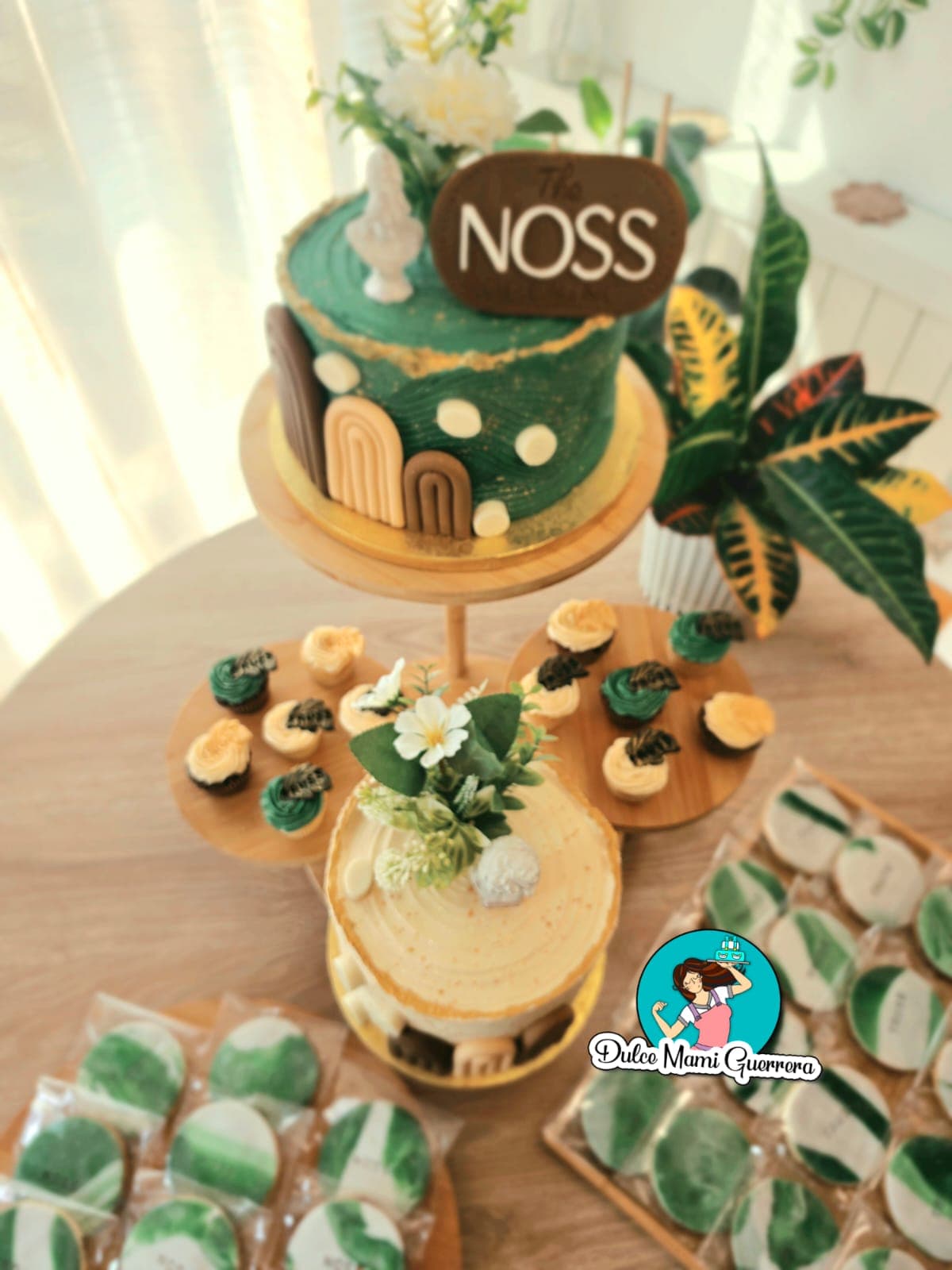 Mesa dulce para evento con tarta personalizada, cupcakes y galletas decoradas en verde y dorado